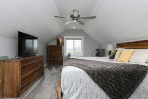 Bedroom featuring carpet floors, lofted ceiling, and ceiling fan