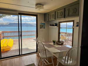 Dining space with wood finished floors and a water view