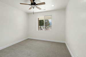 Empty room with light colored carpet, baseboards, a ceiling fan, and visible vents