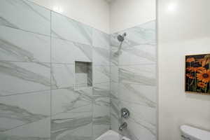 Full bathroom with bathing tub / shower combination and toilet