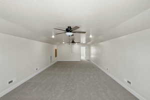 Bonus room featuring vaulted ceiling, baseboards, visible vents, carpet, and a ceiling fan