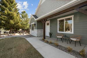 View of side of home featuring board and batten siding and stone siding
