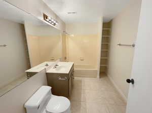 Full bathroom featuring tile patterned floors, a textured ceiling, visible vents, vanity, and tub / shower combination