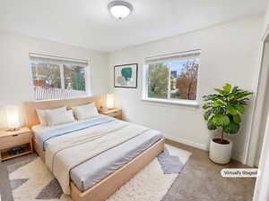Carpeted bedroom featuring baseboards