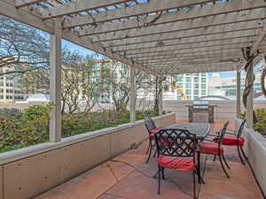 View of patio / terrace with a pergola, outdoor dining space, and a grill
