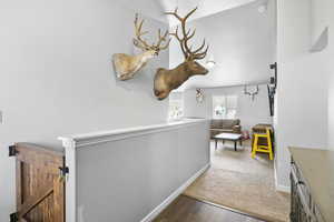 Hallway featuring baseboards and wood finished floors