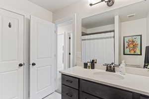 Full bath with visible vents and vanity