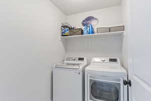 Washroom featuring washer and dryer and laundry area