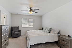 Bedroom featuring visible vents, carpet flooring, baseboards, and a ceiling fan