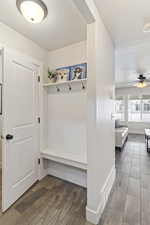 Mudroom with wood finished floors, a textured ceiling, ceiling fan, baseboards, and visible vents