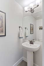 Half bathroom featuring baseboards and wood finished floors