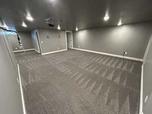 Finished basement with carpet flooring and baseboards