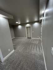 Finished basement featuring baseboards, carpet flooring, and recessed lighting