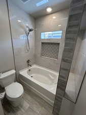 Bathroom with toilet and shower / washtub combination