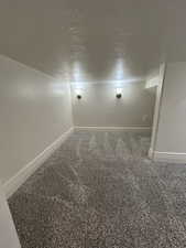Carpeted empty room with baseboards
