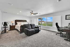 Bedroom featuring ceiling fan, baseboards, visible vents, and carpet
