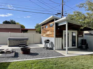 View of patio featuring area for grilling, fence, a hot tub, and french doors