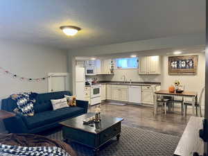 Living area with concrete flooring and a textured ceiling
