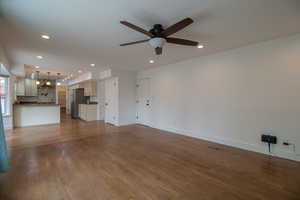 Unfurnished living room featuring recessed lighting, baseboards, dark wood-type flooring, and ceiling fan
