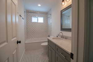 Full bathroom featuring vanity, recessed lighting, shower / tub combination, and toilet