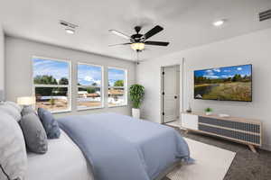 Bedroom with carpet, a ceiling fan, and a textured ceiling