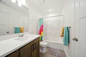 Bathroom with vanity, shower / bathtub combination with curtain, toilet, tile patterned flooring, and visible vents