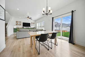 Dining area featuring recessed lighting, light wood finished floors, and ceiling fan with notable chandelier