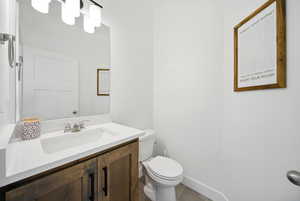 Bathroom featuring vanity, toilet, and tile patterned flooring