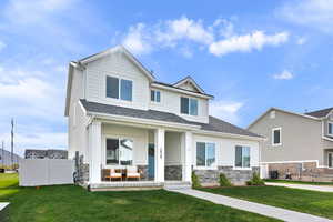 Craftsman house featuring a front lawn, an outdoor living space, stone siding, and a shingled roof