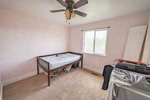 Bedroom with carpet floors, a ceiling fan, and baseboards