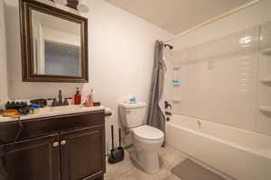 Full bath with shower / tub combo, toilet, and vanity