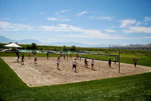 Surrounding community featuring a yard, volleyball court, and a water and mountain view picture courtesy of Saratoga Springs HOA