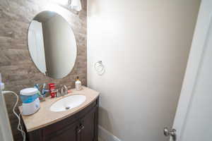 Bathroom with decorative backsplash and vanity