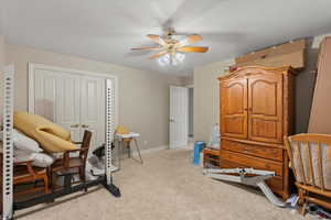 Bedroom featuring carpet, a closet, a ceiling fan, and baseboards