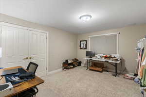 Home office with carpet flooring and baseboards