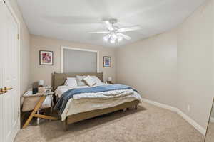 Bedroom with baseboards and a ceiling fan