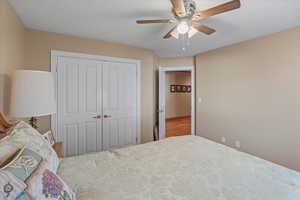 Bedroom featuring a ceiling fan and a closet