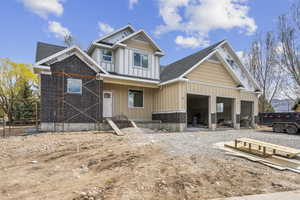 View of front of house with driveway, board and batten siding, and a garage