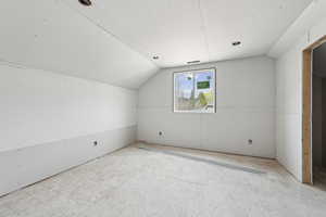 Bonus room with vaulted ceiling and visible vents