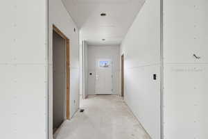 Hall with unfinished concrete flooring