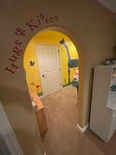 Corridor featuring carpet and arched walkways
