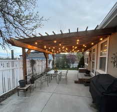 View of patio featuring a grill, fence, outdoor dining space, and a pergola