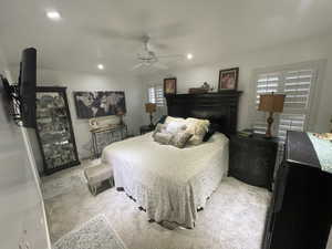 Carpeted bedroom featuring a fireplace, a ceiling fan, and recessed lighting