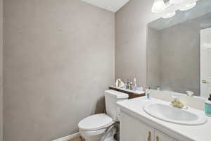 Half bathroom with toilet and vanity