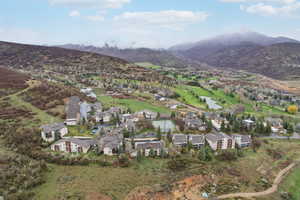 Drone / aerial view featuring a water and mountain view and a residential view
