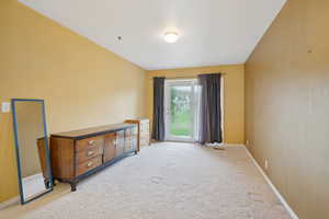 Spare room featuring baseboards and light colored carpet
