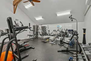 Exercise room with ceiling fan, lofted ceiling, and visible vents