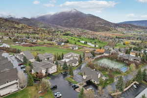 Birds eye view of property with a water and mountain view and a residential view