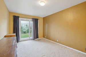Unfurnished room featuring baseboards, visible vents, and carpet