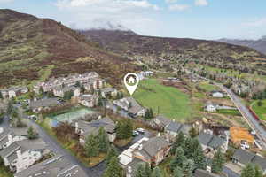 Birds eye view of property featuring a mountain view and a residential view